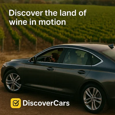 Couple driving through vineyards in Mendoza with DiscoverCars